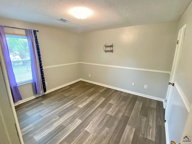 403 Fieldstone Rd, Warner Robins, GA 31093 - unfurnished room with a textured ceiling, dark wood-style floors, and baseboards