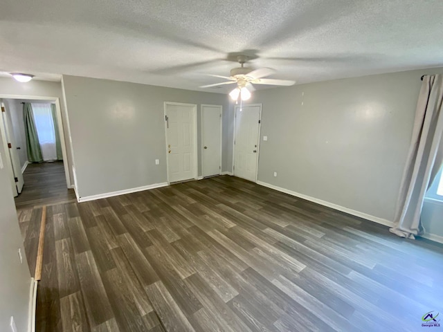 403 Fieldstone Rd, Warner Robins, GA 31093 - empty room with dark wood-style flooring, baseboards, ceiling fan, and a textured ceiling