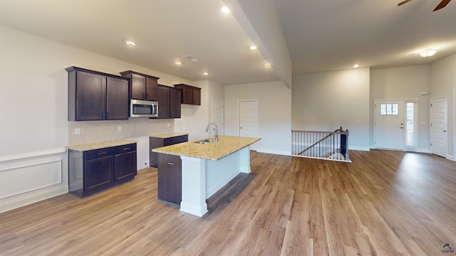 444 Southern Oaks Dr, Macon, GA 31216 - kitchen with a sink, stainless steel microwave, light wood-style floors, dark brown cabinetry, and recessed lighting