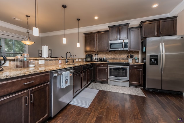 230 Misty Valley Ln, Bonaire, GA 31005 - kitchen with stainless steel appliances, light stone countertops, dark brown cabinets, dark wood-style floors, and crown molding