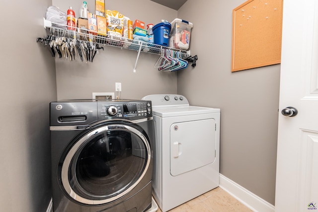 230 Misty Valley Ln, Bonaire, GA 31005 - laundry area featuring washer and dryer and light tile patterned flooring