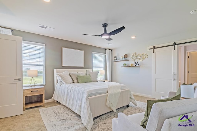 219 Rusty Plow Ln, Perry, GA 31069 - bedroom featuring a barn door, light carpet, a ceiling fan, and recessed lighting