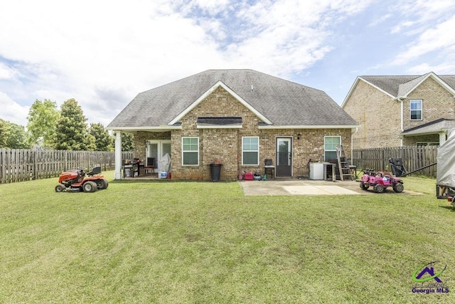 101 Regency Ct, Warner Robins, GA 31088 - rear view of house with a patio area, a fenced backyard, a shingled roof, and brick siding