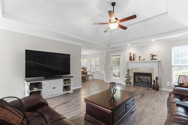 111 Venus Way, Bonaire, GA 31005 - living area with a tray ceiling, wood finished floors, a fireplace, ceiling fan, and ornamental molding