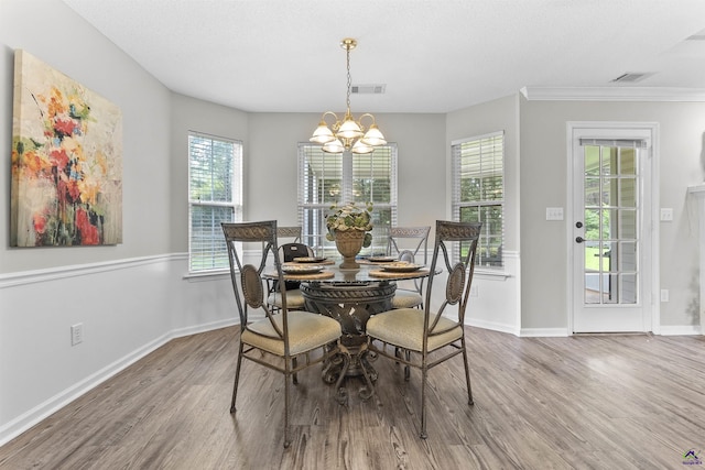 111 Venus Way, Bonaire, GA 31005 - dining area featuring wood finished floors, a chandelier, and crown molding