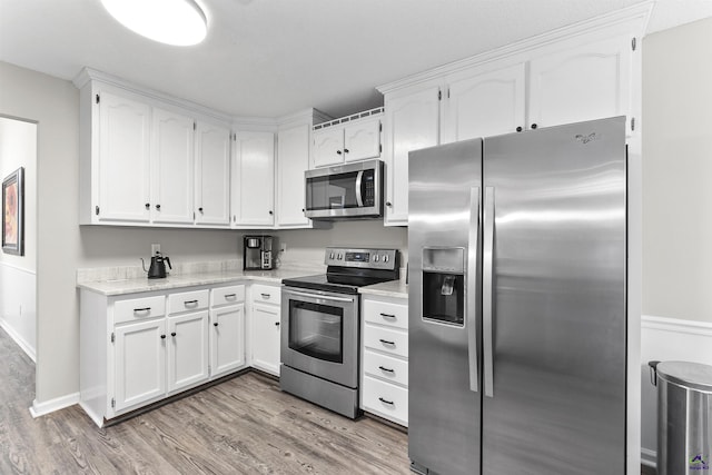 111 Venus Way, Bonaire, GA 31005 - kitchen featuring stainless steel appliances, light wood-type flooring, white cabinets, and light countertops