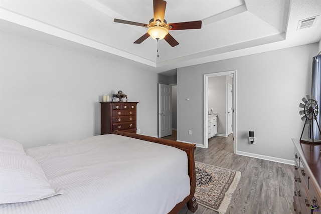 111 Venus Way, Bonaire, GA 31005 - bedroom featuring a raised ceiling, wood finished floors, and a ceiling fan