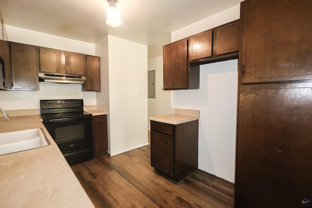 431 Alabama Ave, Warner Robins, GA 31093 - kitchen with under cabinet range hood, black electric range oven, light countertops, and electric panel