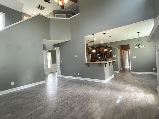 228 Piedmont Ln, Bonaire, GA 31005 - unfurnished living room with a ceiling fan, a high ceiling, and dark wood-style flooring