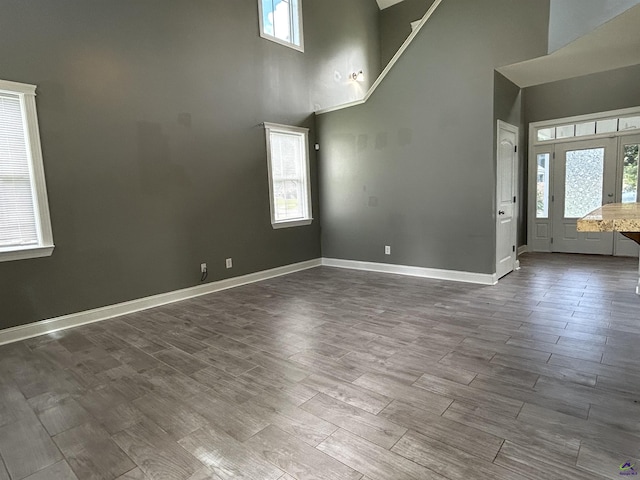 228 Piedmont Ln, Bonaire, GA 31005 - spare room with high vaulted ceiling and dark wood finished floors