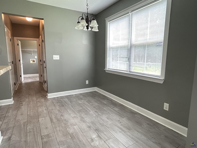 228 Piedmont Ln, Bonaire, GA 31005 - spare room featuring a chandelier and wood finished floors