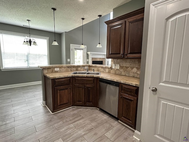 228 Piedmont Ln, Bonaire, GA 31005 - kitchen with stainless steel dishwasher, light countertops, a textured ceiling, and dark brown cabinets