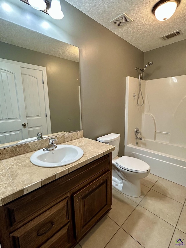 228 Piedmont Ln, Bonaire, GA 31005 - bathroom with vanity, tile patterned floors, shower / tub combination, and a textured ceiling
