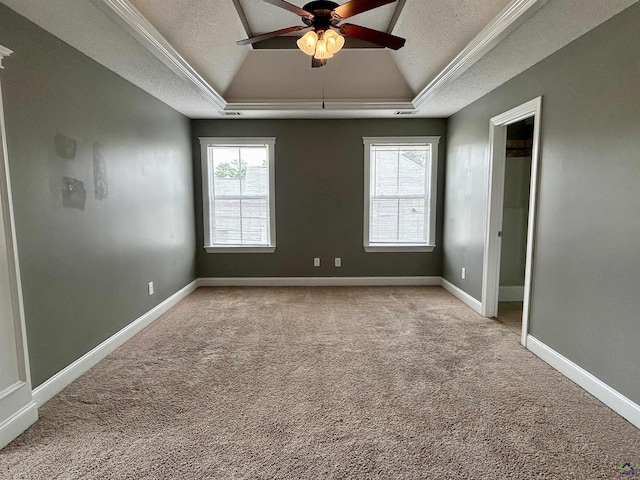 228 Piedmont Ln, Bonaire, GA 31005 - spare room featuring a tray ceiling, a textured ceiling, light colored carpet, ceiling fan, and crown molding