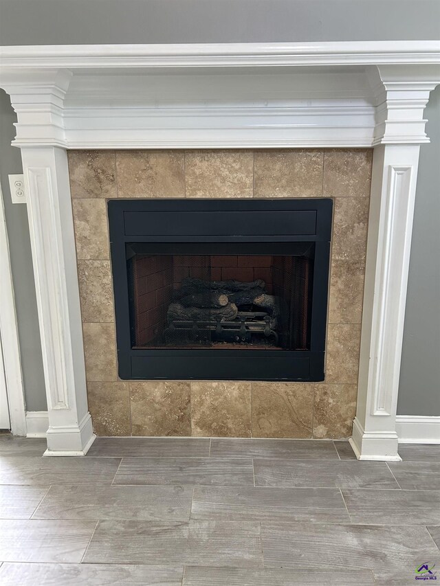 228 Piedmont Ln, Bonaire, GA 31005 - detailed view of a tiled fireplace, ornate columns, ornamental molding, and wood finished floors