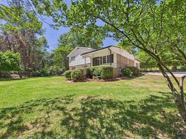 3610 Bonanza Dr, Macon, GA 31216 - view of side of property with brick siding and a yard