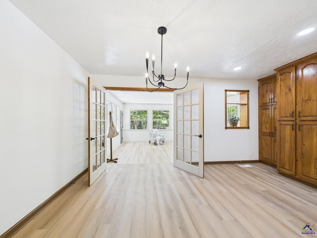 3610 Bonanza Dr, Macon, GA 31216 - unfurnished dining area with french doors, light wood finished floors, a chandelier, and recessed lighting