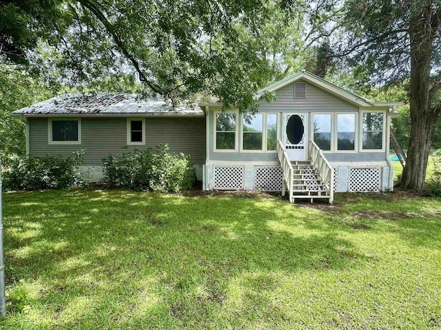 676 N 2nd St, Danville, GA 31017 - view of front of house with a front lawn, a sunroom, and entry steps