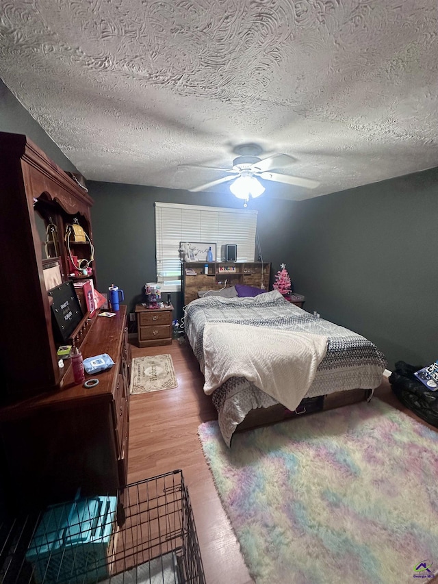 676 N 2nd St, Danville, GA 31017 - bedroom with a textured ceiling, a ceiling fan, and wood finished floors