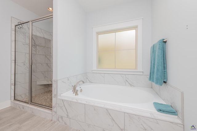 202 Brook Hollow Ct, Kathleen, GA 31047 - bathroom featuring a garden tub, a shower stall, and wood finished floors
