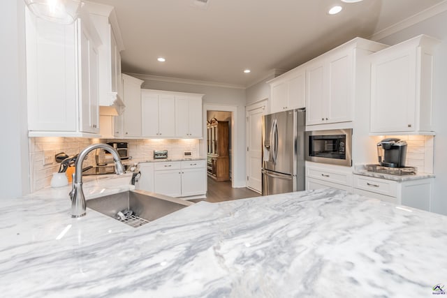 202 Brook Hollow Ct, Kathleen, GA 31047 - kitchen with stainless steel refrigerator with ice dispenser, built in microwave, crown molding, recessed lighting, and white cabinets