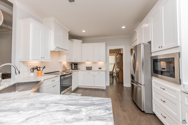 202 Brook Hollow Ct, Kathleen, GA 31047 - kitchen with stainless steel appliances, white cabinetry, tasteful backsplash, ornamental molding, and recessed lighting
