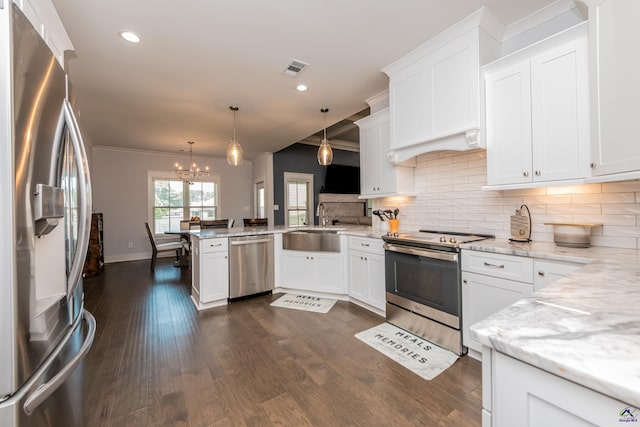 202 Brook Hollow Ct, Kathleen, GA 31047 - kitchen featuring stainless steel appliances, a peninsula, tasteful backsplash, a chandelier, and ornamental molding