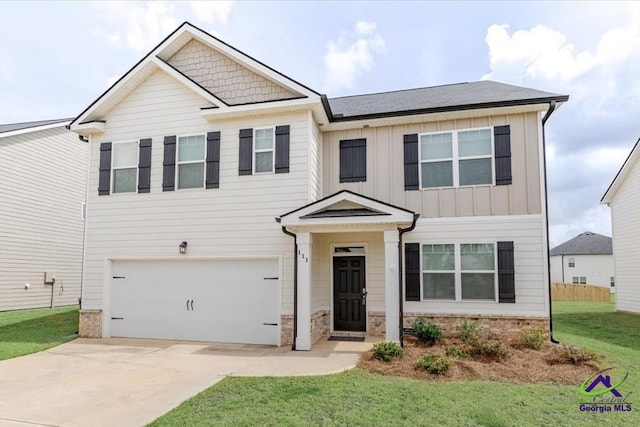 111 Farmers Way, Perry, GA 31069 - view of front of home with an attached garage, board and batten siding, driveway, and a front lawn