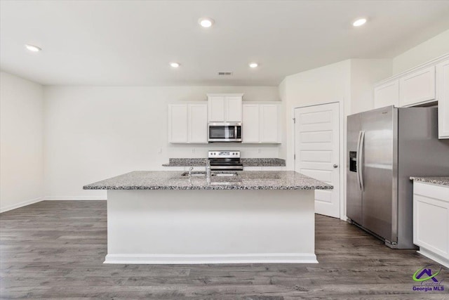 111 Farmers Way, Perry, GA 31069 - kitchen with stainless steel appliances, light stone counters, a center island with sink, and recessed lighting
