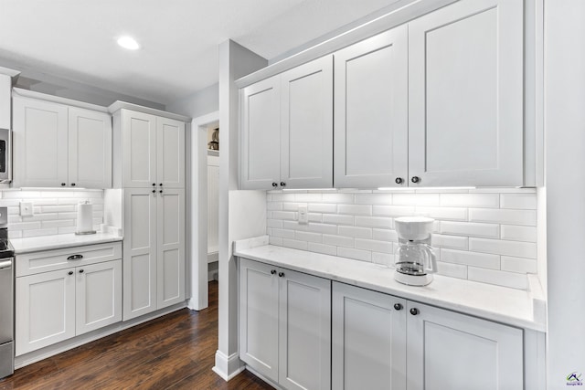 304 Kendall Ct, Perry, GA 31069 - kitchen featuring dark wood finished floors, decorative backsplash, white cabinetry, recessed lighting, and light stone countertops