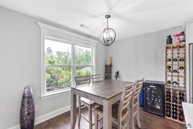 304 Kendall Ct, Perry, GA 31069 - dining room with beverage cooler, a chandelier, and dark wood finished floors
