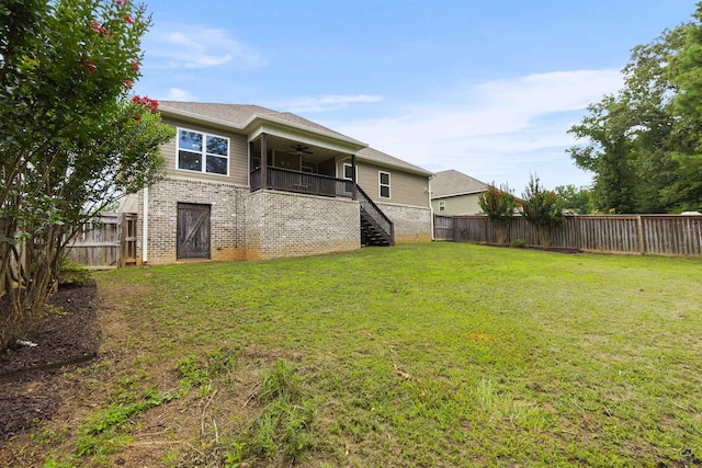 304 Kendall Ct, Perry, GA 31069 - rear view of house with a ceiling fan, stairs, a fenced backyard, and brick siding