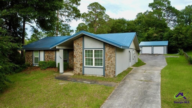 102 Overlook Dr, Warner Robins, GA 31088 - view of front of home featuring stone siding, a garage, a front yard, an outdoor structure, and a metal roof