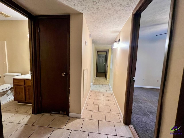 102 Overlook Dr, Warner Robins, GA 31088 - corridor featuring light tile patterned flooring and a textured ceiling