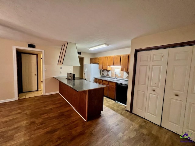 102 Overlook Dr, Warner Robins, GA 31088 - kitchen with black dishwasher, white refrigerator with ice dispenser, a peninsula, and dark wood-type flooring