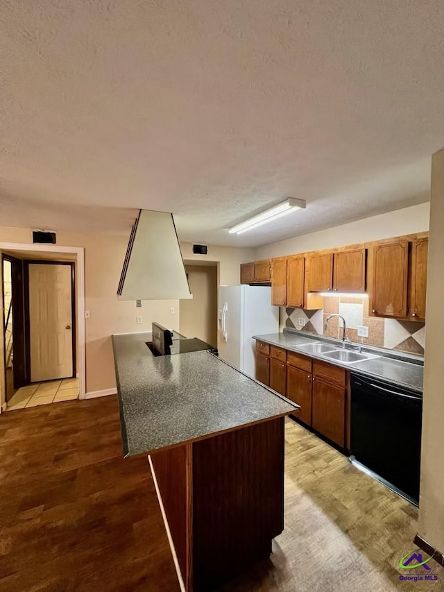 102 Overlook Dr, Warner Robins, GA 31088 - kitchen featuring dishwasher, white fridge with ice dispenser, a textured ceiling, a peninsula, and brown cabinetry