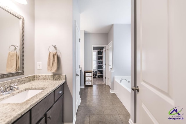 501 Adirondac Way, Bonaire, GA 31005 - bathroom featuring vanity, tile patterned floors, and a garden tub
