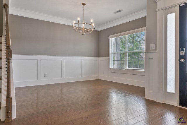 104 Taylor Leigh Ct, Kathleen, GA 31047 - empty room featuring a chandelier, ornamental molding, a wainscoted wall, dark wood finished floors, and a decorative wall