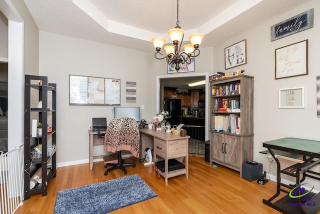 222 Duke Ln, Kathleen, GA 31047 - office area featuring wood finished floors, a chandelier, and a raised ceiling