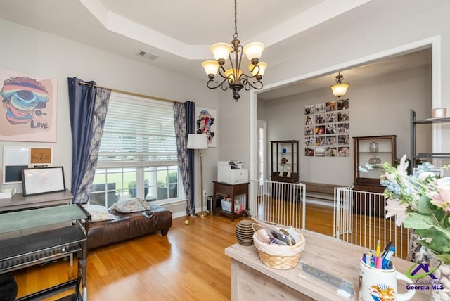 222 Duke Ln, Kathleen, GA 31047 - living area featuring a chandelier, wood finished floors, and a raised ceiling