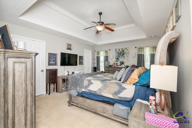 222 Duke Ln, Kathleen, GA 31047 - bedroom featuring a tray ceiling, light carpet, and ceiling fan