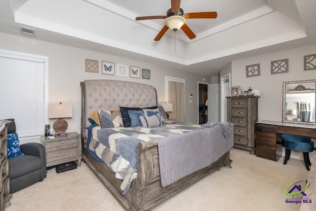 222 Duke Ln, Kathleen, GA 31047 - bedroom with a tray ceiling, light carpet, and a ceiling fan