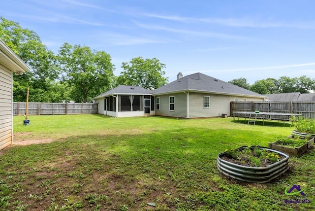 222 Duke Ln, Kathleen, GA 31047 - back of house with a fenced backyard, a sunroom, and a trampoline