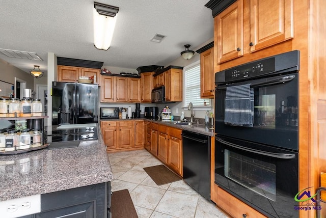 222 Duke Ln, Kathleen, GA 31047 - kitchen featuring black appliances, dark countertops, brown cabinets, light tile patterned flooring, and a textured ceiling