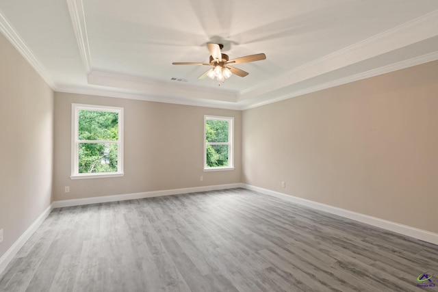 219 Christine Cir, Perry, GA 31069 - empty room featuring a tray ceiling, wood finished floors, ornamental molding, and ceiling fan