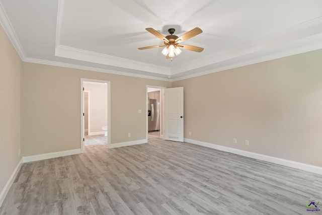 219 Christine Cir, Perry, GA 31069 - spare room featuring a raised ceiling, ornamental molding, light wood finished floors, and ceiling fan