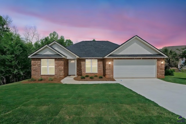 219 Christine Cir, Perry, GA 31069 - view of front facade featuring a garage, concrete driveway, a front lawn, brick siding, and roof with shingles