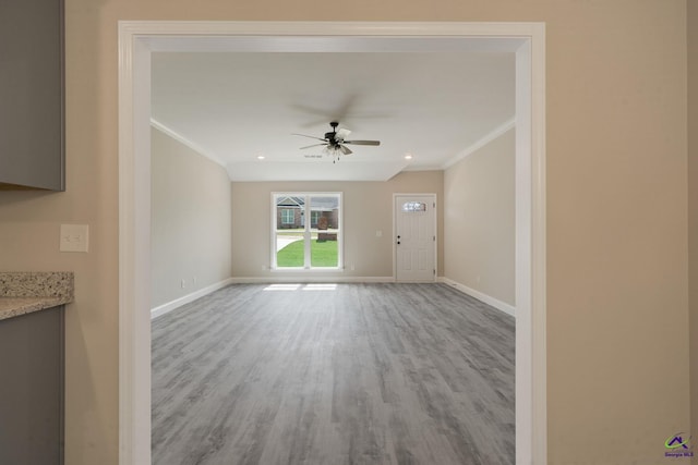 219 Christine Cir, Perry, GA 31069 - unfurnished living room featuring crown molding, a ceiling fan, and wood finished floors