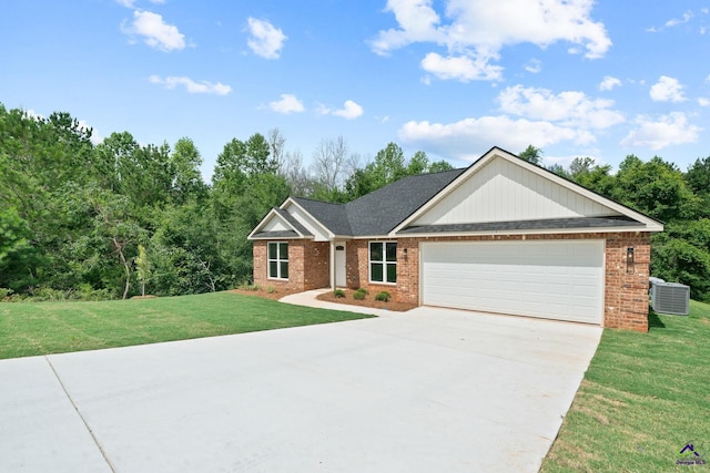219 Christine Cir, Perry, GA 31069 - view of front of house with brick siding, a garage, driveway, and a front lawn