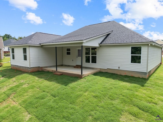 219 Christine Cir, Perry, GA 31069 - back of property with a patio area, a lawn, and roof with shingles